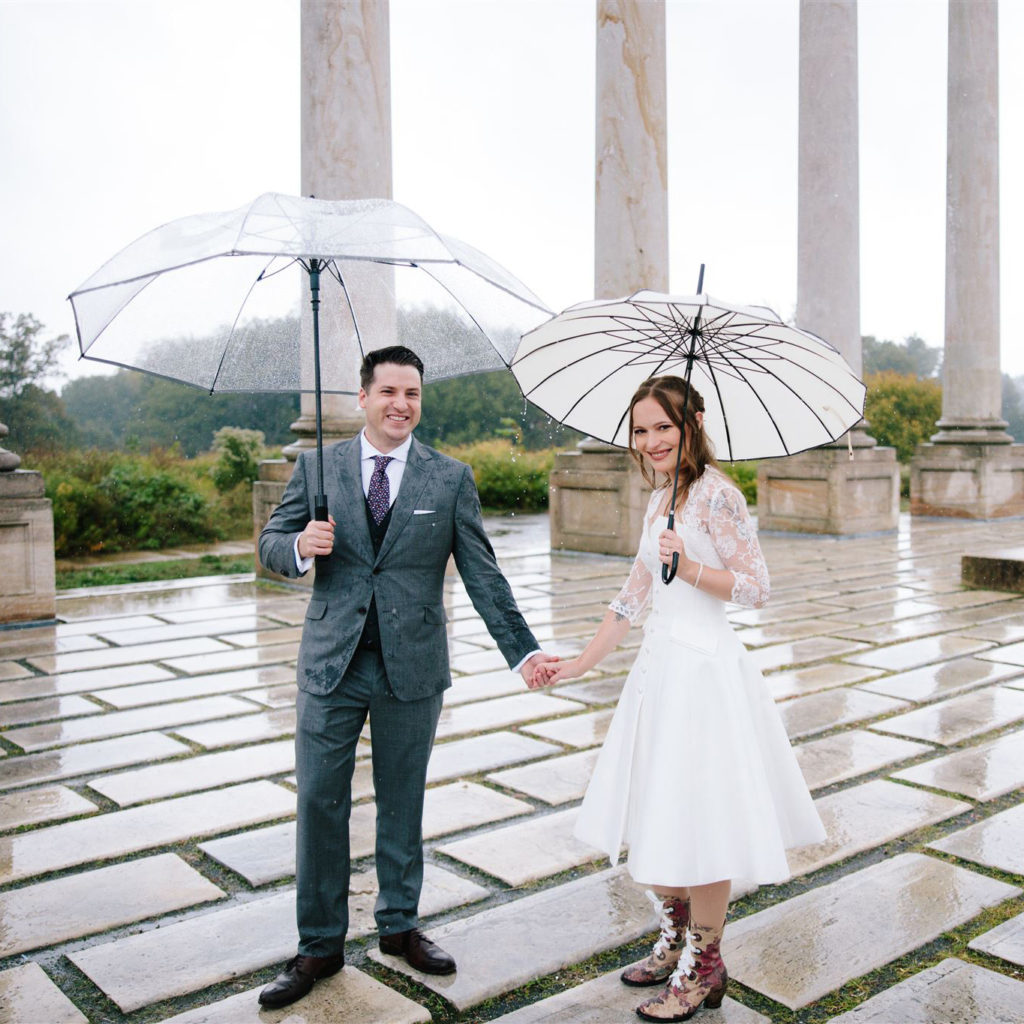 bride and groom holding hands amongst the capitol columns