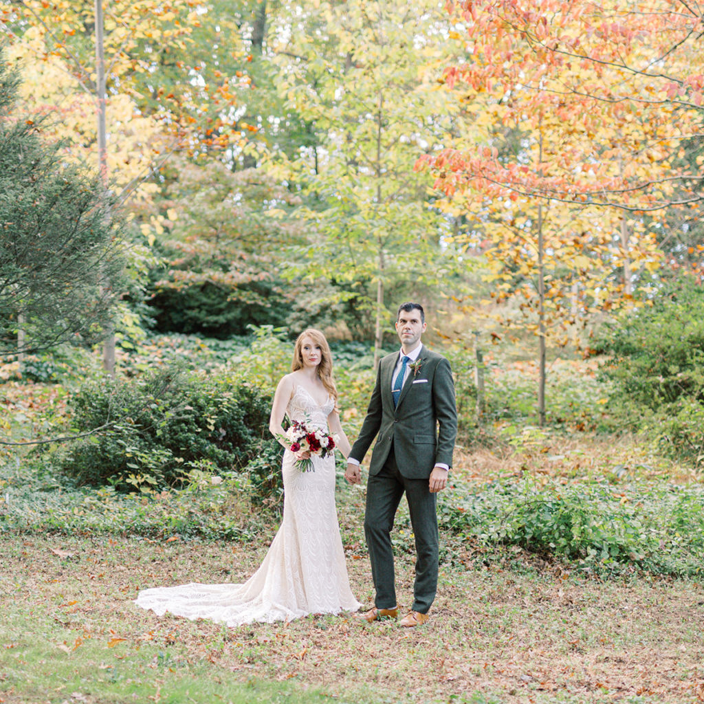 Bride and groom standing together in a garden