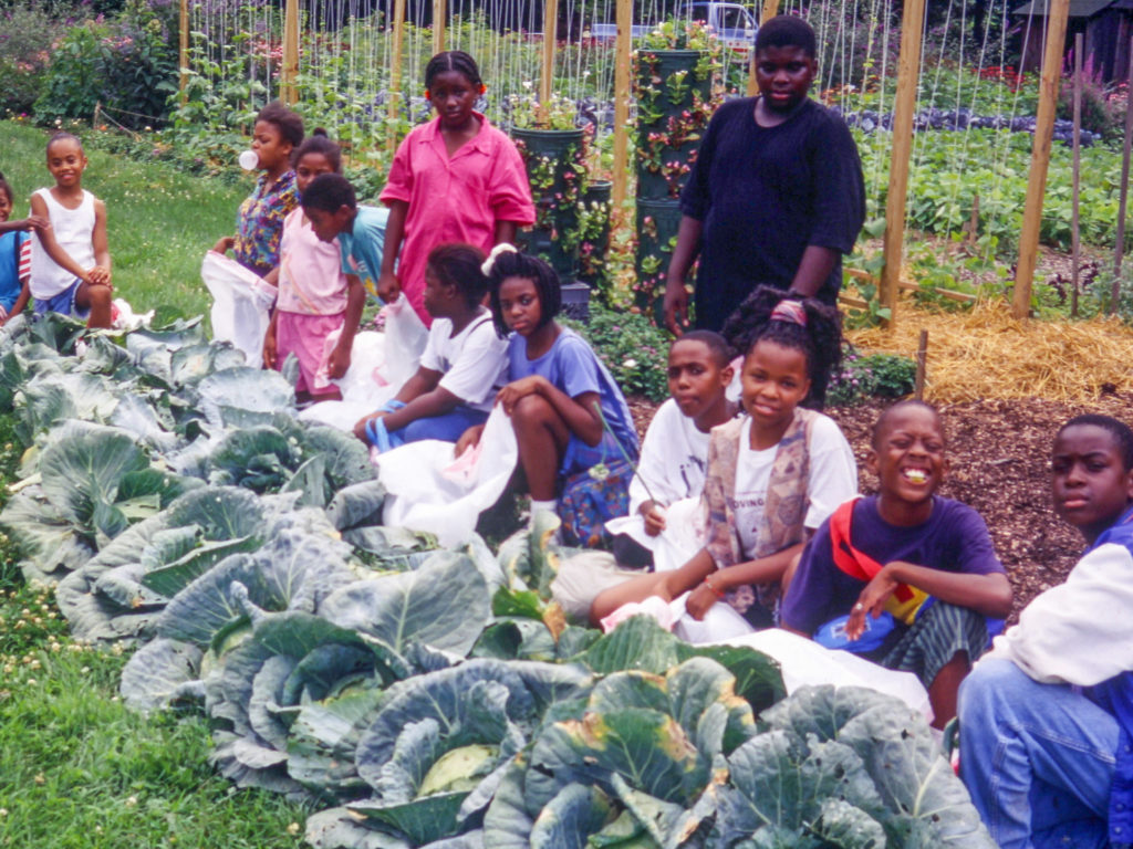 historic photo of students posing in front of cabbages in the washington youth garden