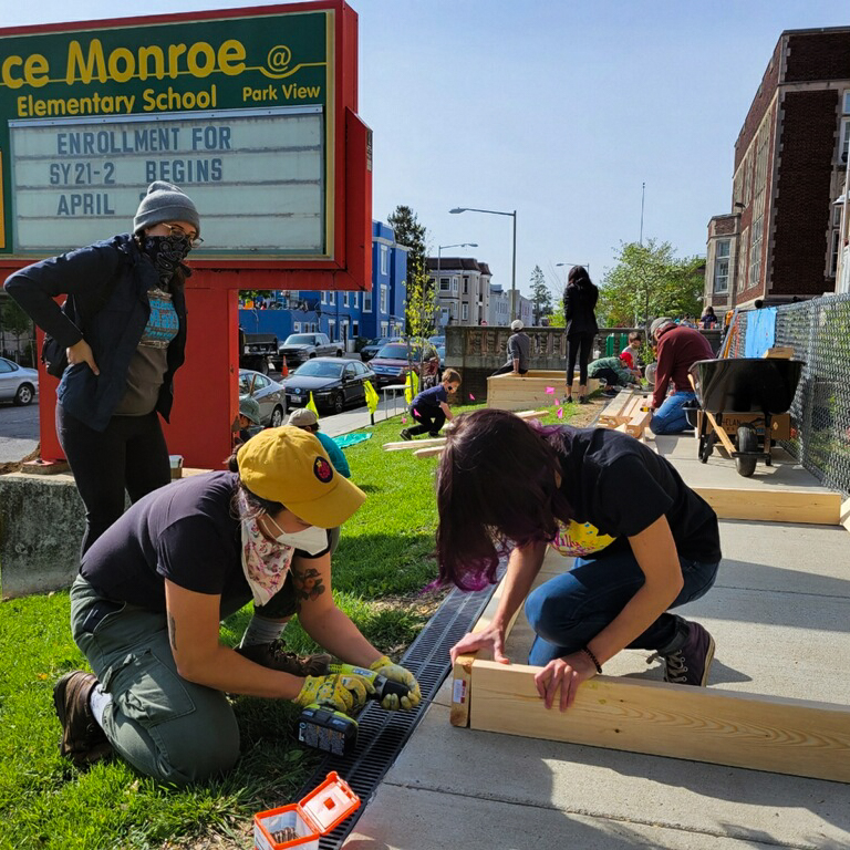 FONA staff helping educators at partner schools build new raised garden beds