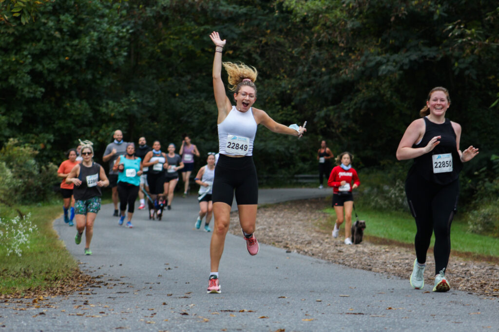 fall 5k runners jumping in the air