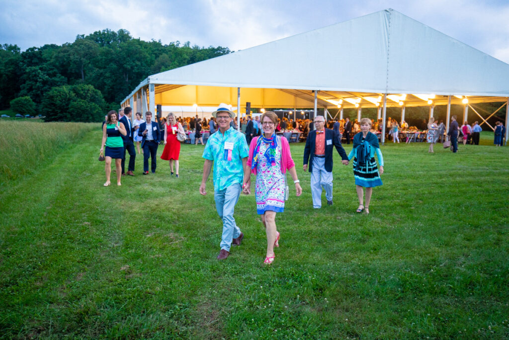 dinner under the stars guests walking from the dinner tent to the columns