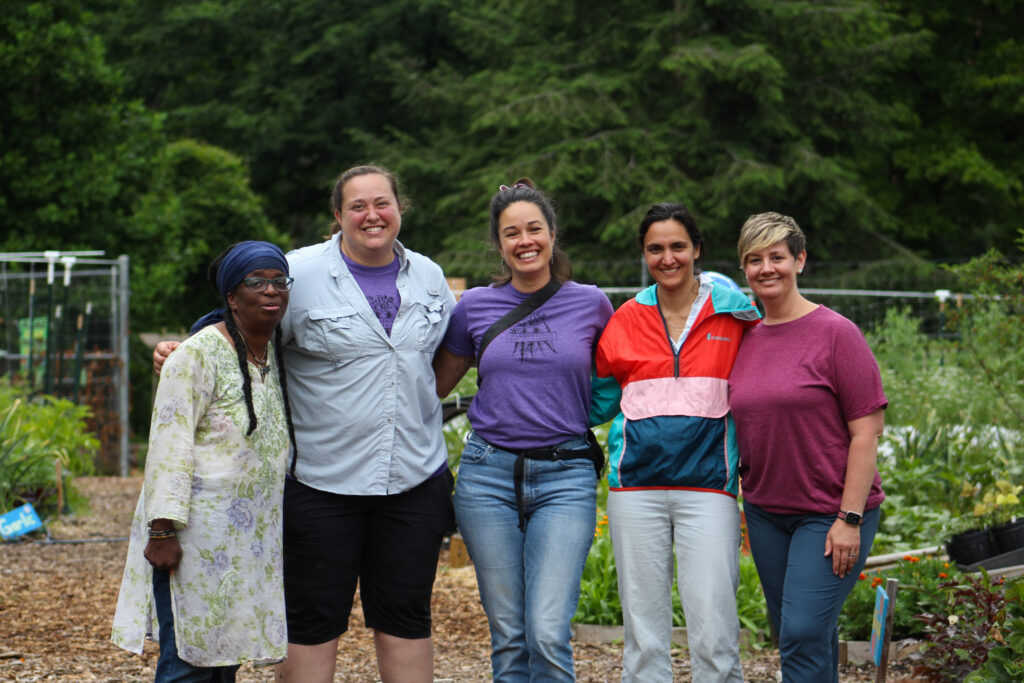 former washington youth garden dirrectors and program manager pose together in the garden