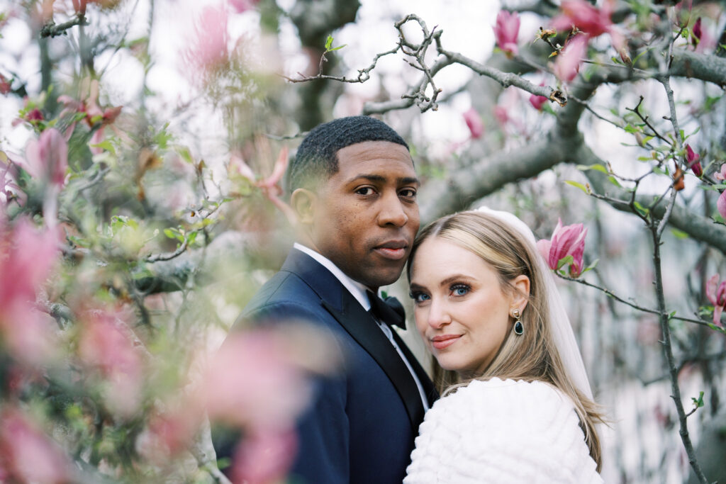 Bride and groom posing in the Holly and Magnolia Collection