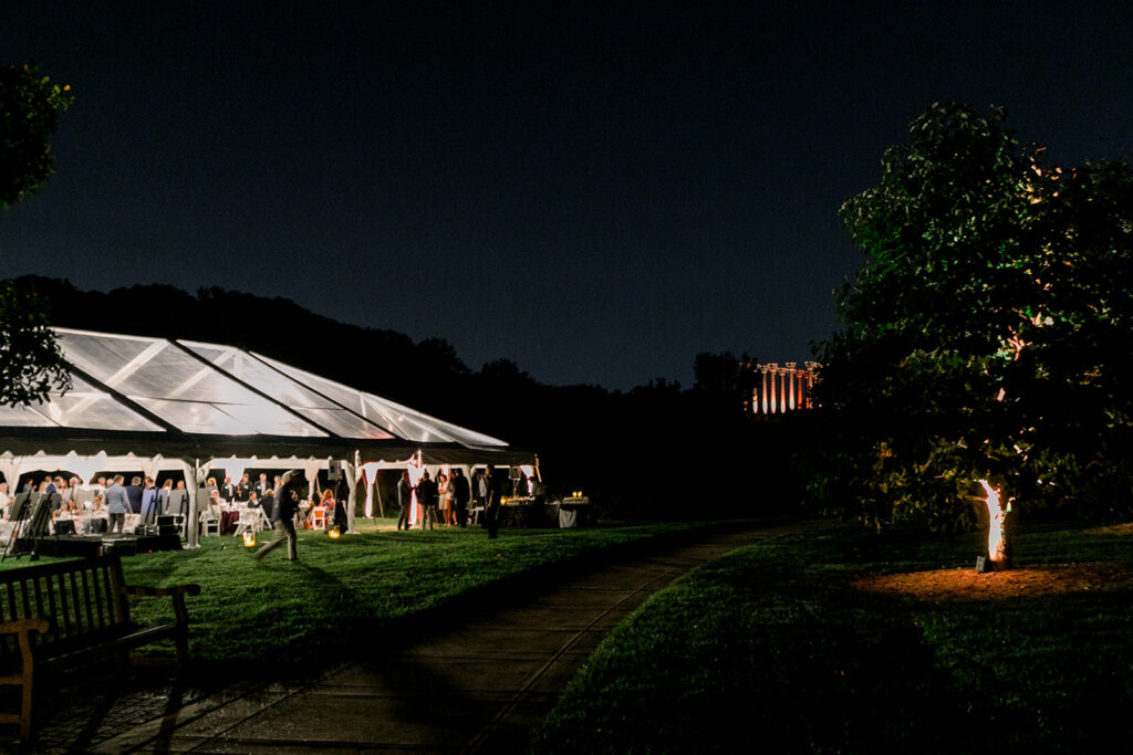 Dinner Under the Stars tent lit up at night with the capitol columns in the background