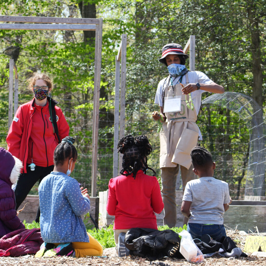 Educator leading a SPROUT field trip in the Washington Youth Garden