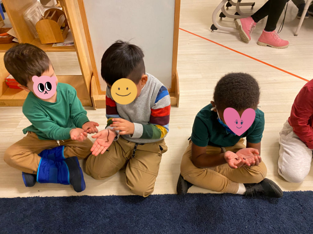 students holding worms