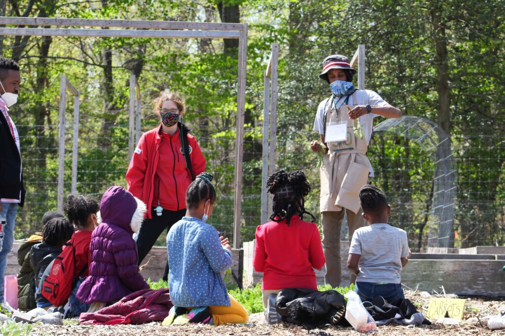 Educator leading a SPROUT field trip in the Washington Youth Garden