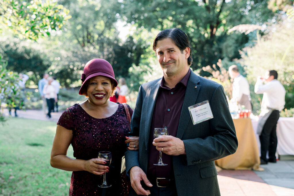 dinner under the stars attendees posing and smiling for the camera in the national herb garden