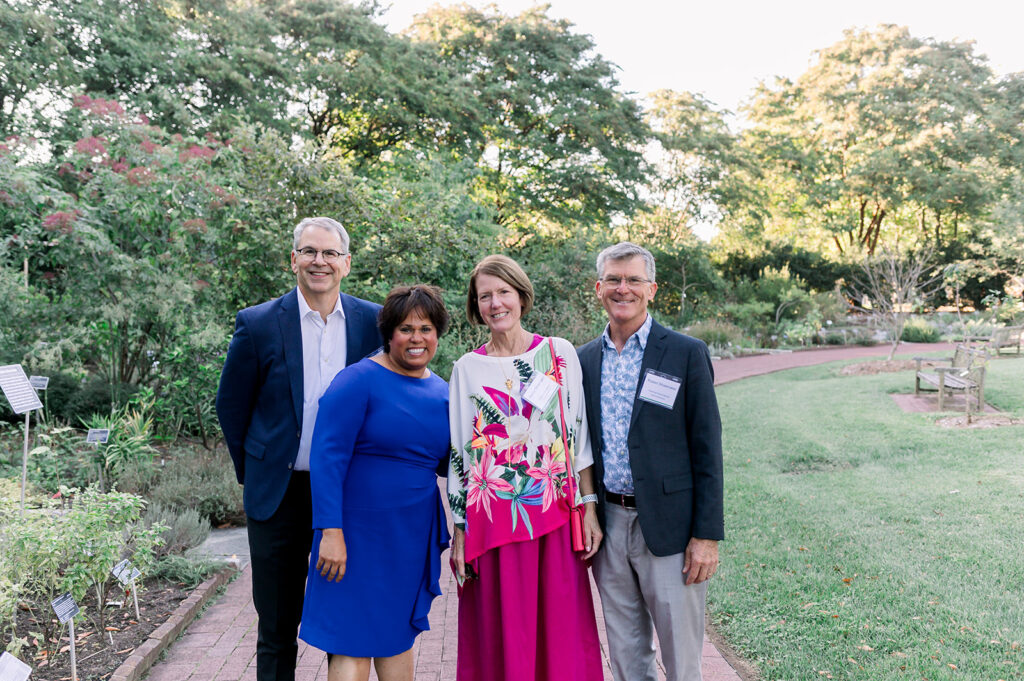 dinner under the stars attendees posing and smiling for the camera in the national herb garden