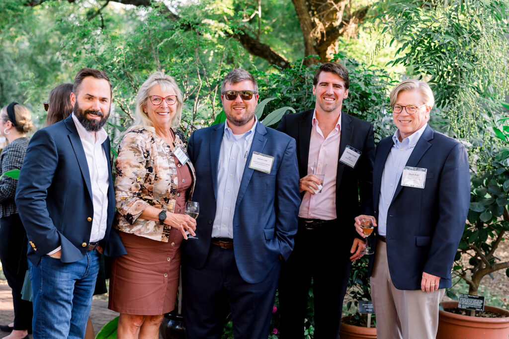 dinner under the stars attendees posing and smiling for the camera in the national herb garden