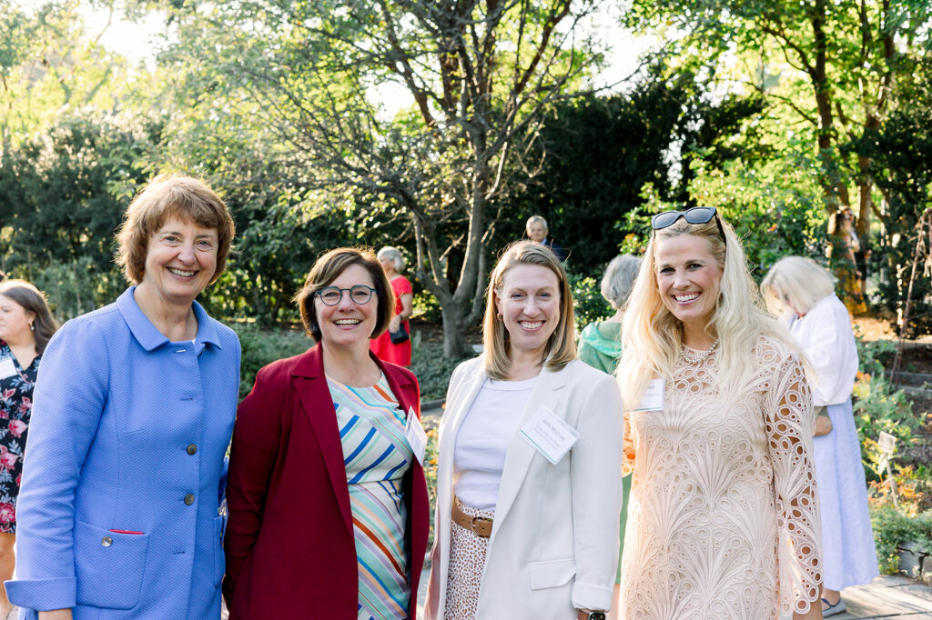 dinner under the stars attendees posing and smiling for the camera in the national herb garden