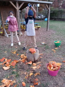 students smashing pumpkins at friendship woodridge