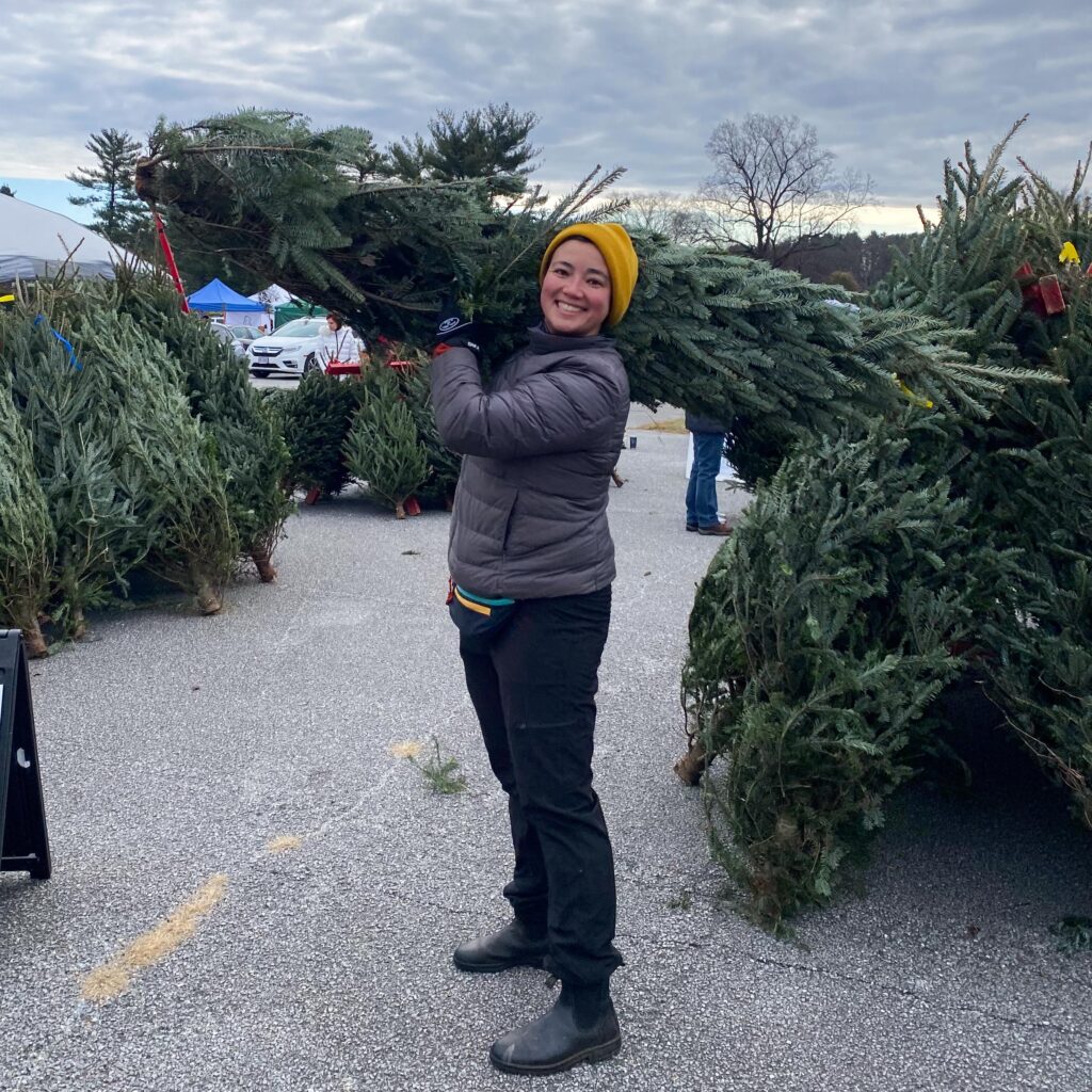 Emilia holding a christmas tree during the annual winter festival and tree sale