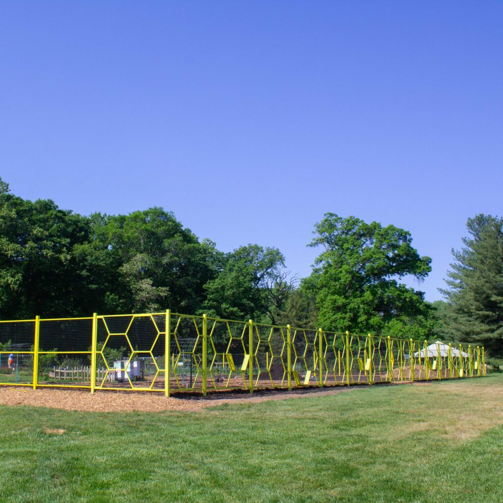 The Washington Youth Garden's new fence features an yellow honeycomb design and front entrance gate.