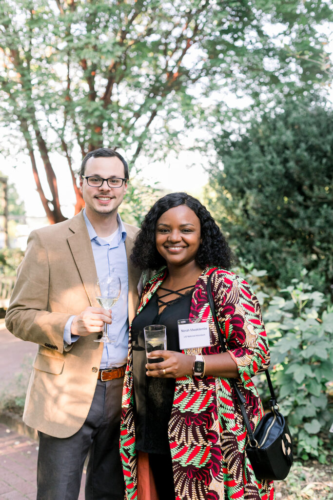 Dinner under the stars attendees in the national herb garden during cocktail hour