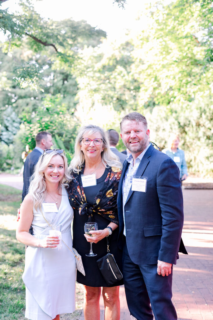 Dinner under the stars attendees in the national herb garden during cocktail hour