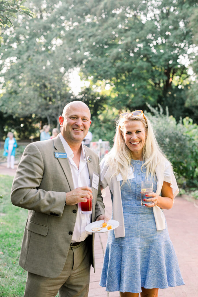 Dinner under the stars attendees in the national herb garden during cocktail hour