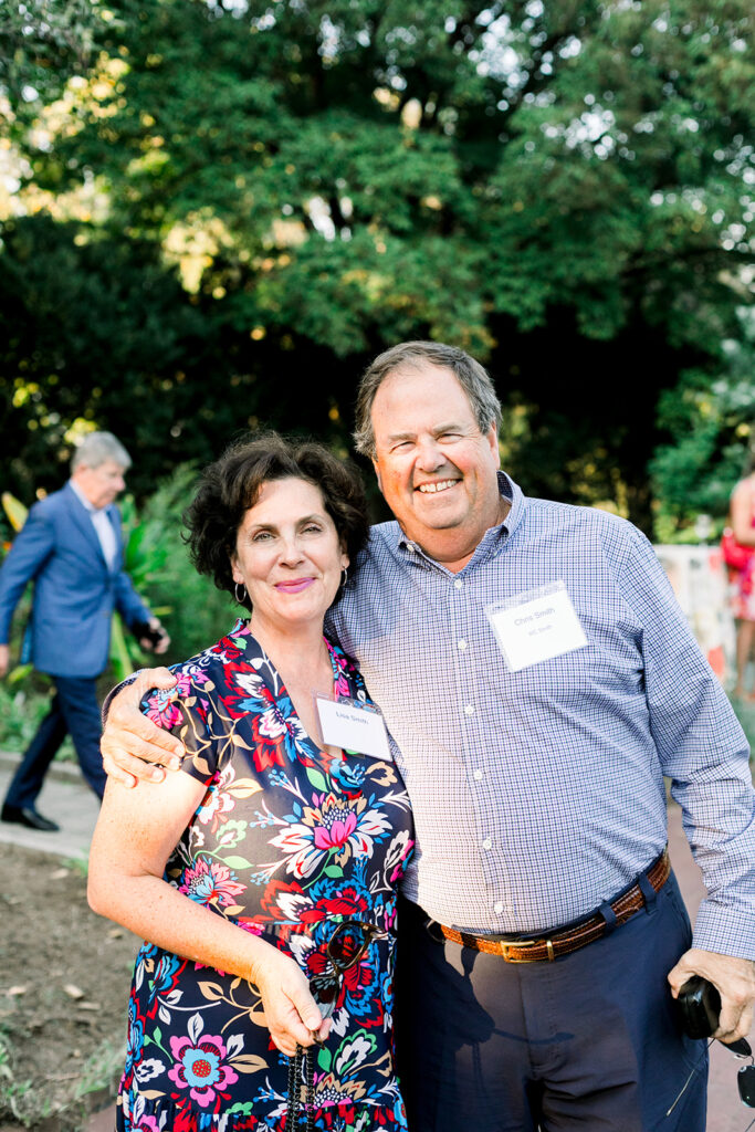 Dinner under the stars attendees in the national herb garden during cocktail hour