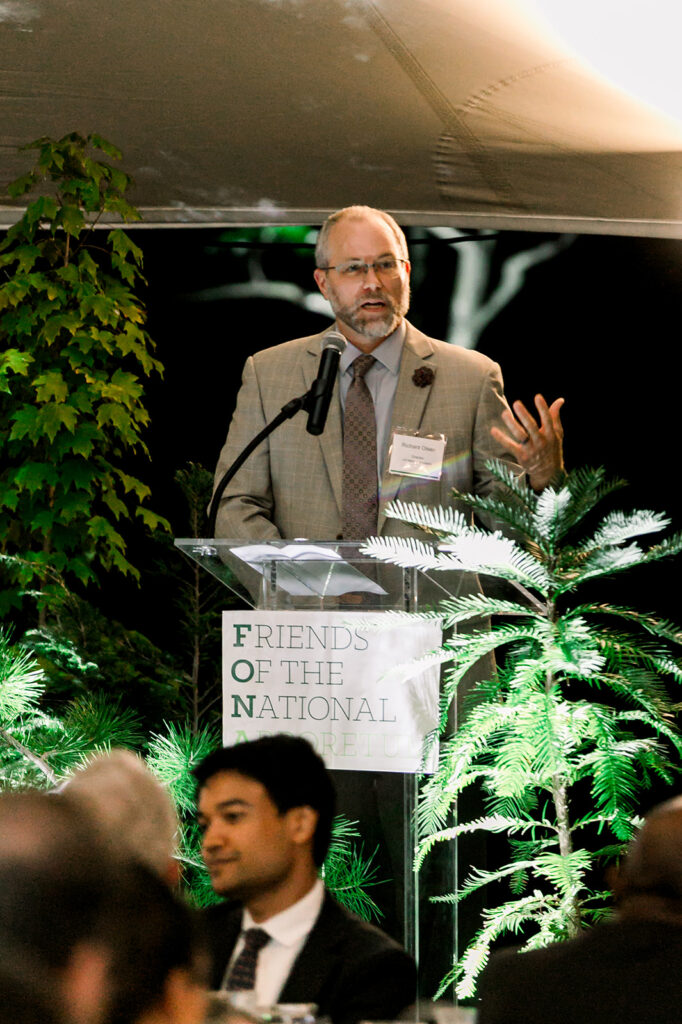 Dr. Richard T. Olsen speaking during dinner under the stars
