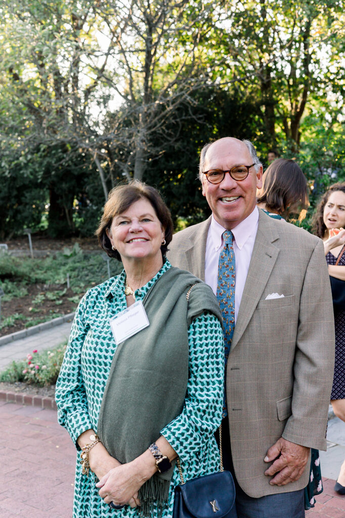 Dinner under the stars attendees in the national herb garden during cocktail hour