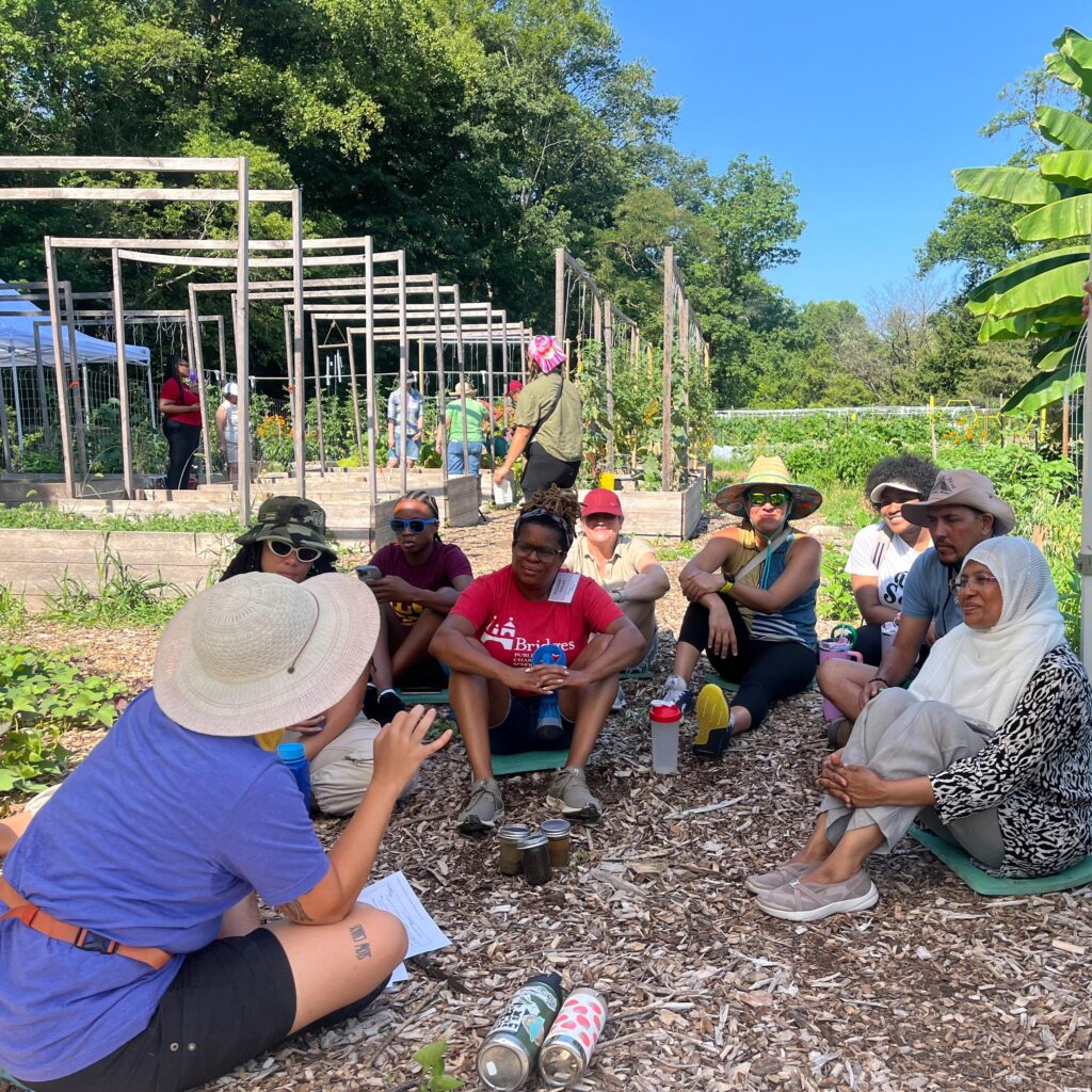 Educators listening to a session of the summer institute for garden-based teaching in the washington youth garden