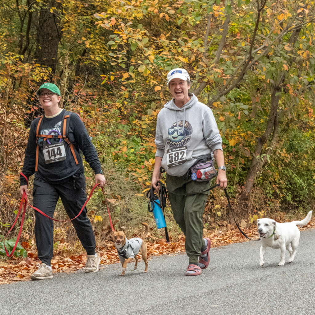 Two 5k participants with their dogs during the fall 5k