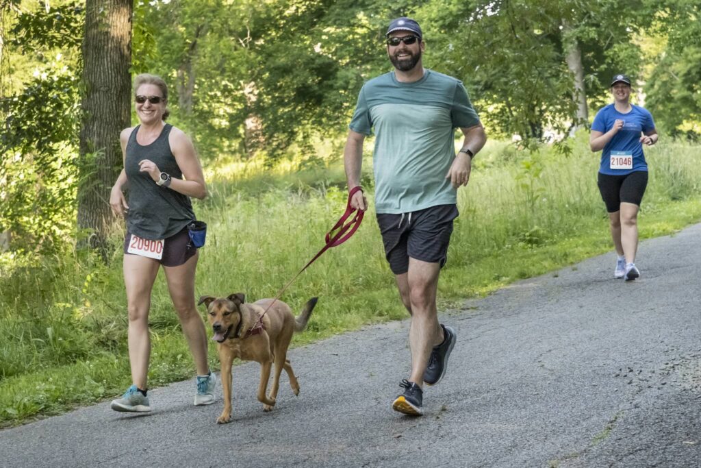 two summer 5k runners with their dog