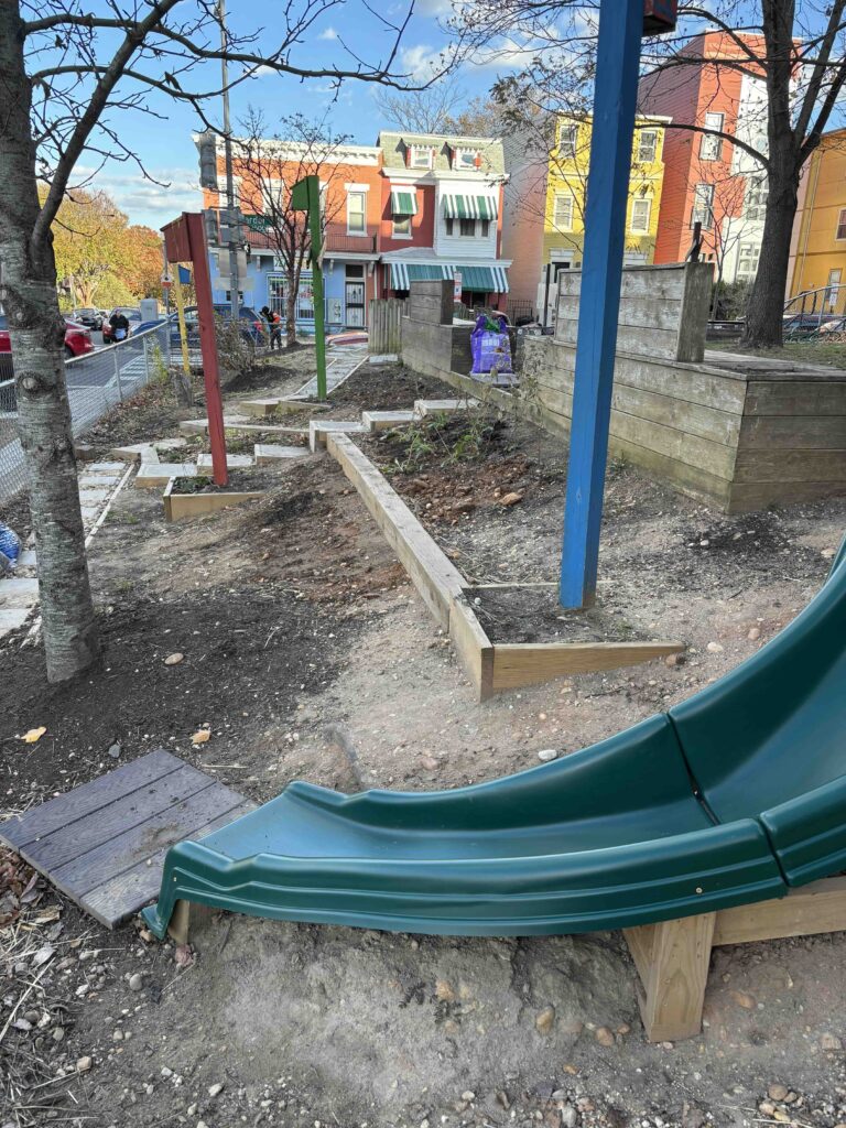 Renovated school garden at Bruce Monroe Elementary School, with a new slide and pathway