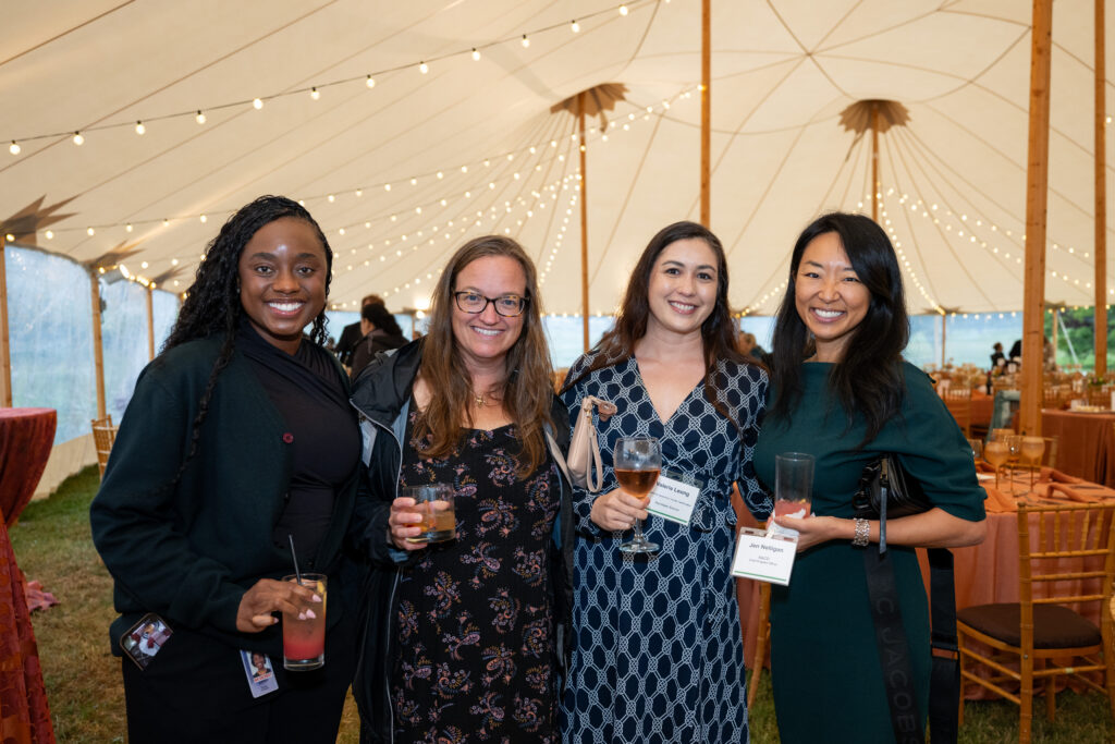 Dinner Under the Stars attendees smiling and holding drinks